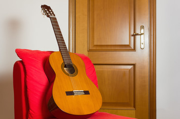 Classical Guitar on a Red Easy Chair