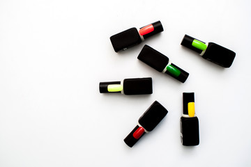 Bottles of nail polish on a colorful wooden table