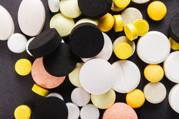 Pills close up on black background.