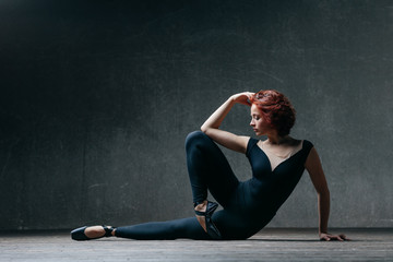 Fototapeta na wymiar Young beautiful ballerina posing in studio