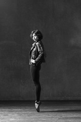Young beautiful ballerina posing in studio