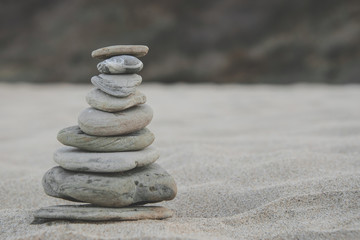Fototapeta na wymiar Pebble stack on the seashore. Zen Concept of Concentration and Relaxation.