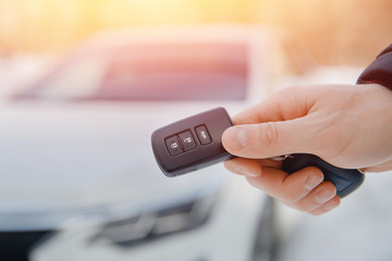 Key of car. Man holds car alarm key.