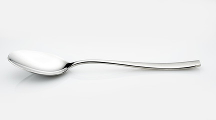 Isolated spoon on a glossy white background