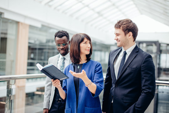 friendly multinational, business team having discussion on note in office
