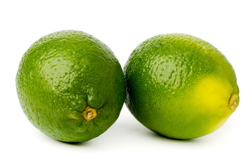 Two green limes on a white, isolated.
