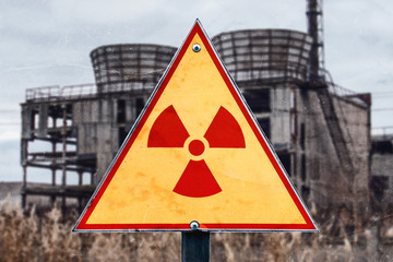 Sign of radiation hazard against radioactive waste on the building background, picture with a place...