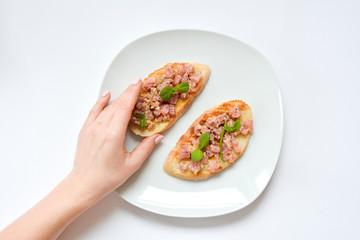 tuna tartare on the bread and white plate