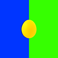 yellow painted egg on blue, green background