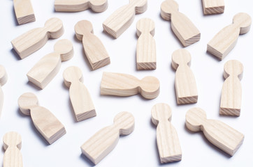 Wooden figures of people on a white background. The concept of society, collective, company, family, neighbors. A crowd of people at a meeting, rally. Workers, employees, citizens. Kids toys. Close up