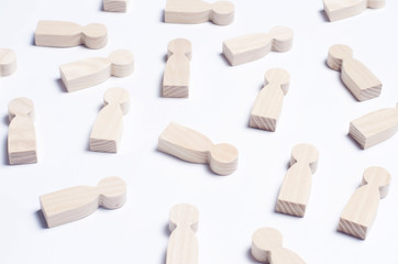 Wooden figures of people on a white background. The concept of society, collective, company, family, neighbors. A crowd of people at a meeting, rally. Workers, employees, citizens. Kids toys. Close up
