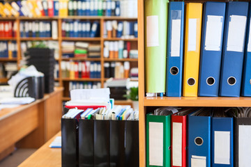 Archive department room with a lot of colourful file binders