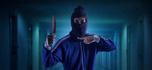 Criminal or bandit holding a knife.