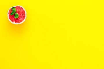 Natural citrus cosmetics. Spa salt near grapefruit on yellow background top view mockup