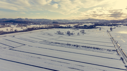 Aerial view of snow covered countryside.