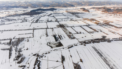 Aerial view of snow covered countryside.