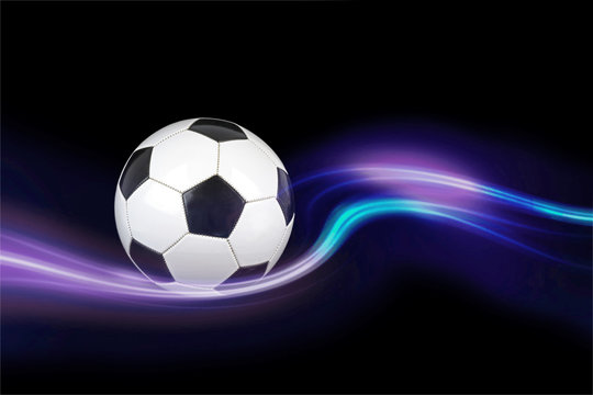 Soccer ball with colorful effects on black background.