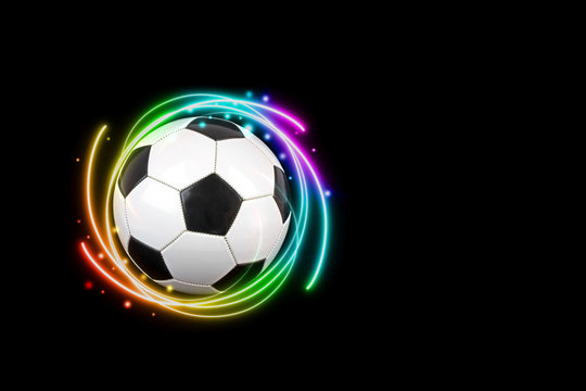 Soccer ball with colorful effects on black background.