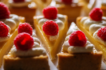 product photography of lemon cheesecake with raspberries on white background, zig zag pattern of cake slices 