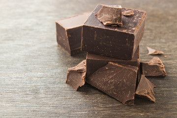Dark chocolate on a wooden background