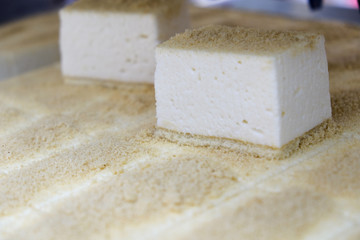 Cutting machine for cakes in action, cut into pieces biscuit