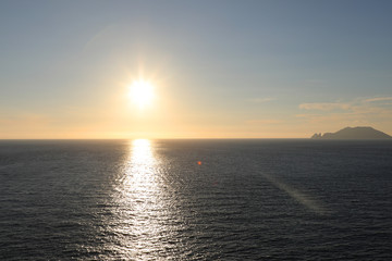 Sea and sunset with sun rays.