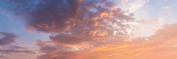 Fototapeta na wymiar Fiery orange very beautiful sunset sky. Dramatic clouds after rain