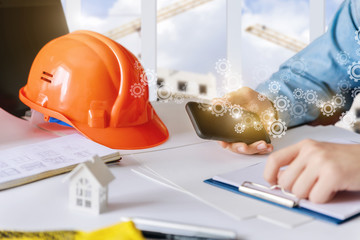 Builder is working on the phone at the Desk.