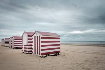 Gardinen Row of colorful beach huts on deserted beach © Erik_AJV
