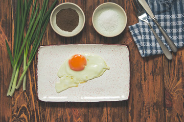 Fried egg breakfast green onion vintage wooden background