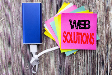 Web Solutions. Business concept for Internet Design Plan written on sticky note with copy space on old wood wooden background with power bank