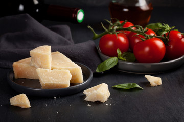Traditional ingridients of italian cuisine: parmesan cheese, tomatoes, basil, olive oil, red wine