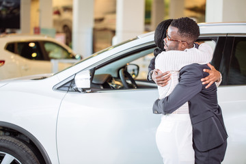 Couple collecting a new car from salesman on lot © alfa27