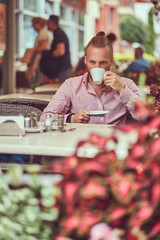 A handsome redhead male with a stylish haircut and beard in pink