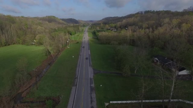 Following Highway Through Lush Green Hills