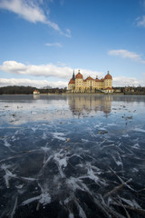 Castle Moritzburg in Dresden with reflections in the ice in the winter.