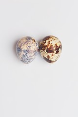 two quail eggs on a white background. preparation for Easter