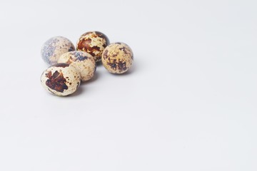 five quail eggs on a white background. preparation for Easter