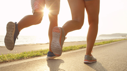 LOW ANGLE SUN FLARE Fit couple on relaxing jog with stunning view of sunny coast