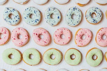 Flat lay donuts pattern on a white background.