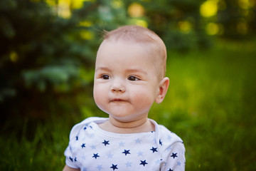 A boy smiles against a background