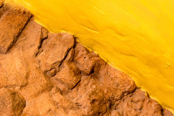 Background texture brickt stone wall and yellow painted wall