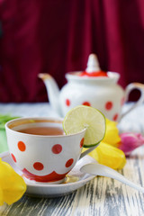 morning breakfast of tea in a cup of colorful peas with pink flowers