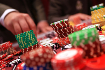 Player placing chips on a gambling table in casino