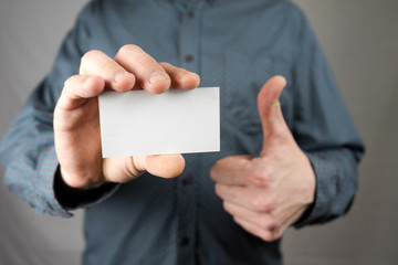 Businessman holding a business card. Mock up. Copy space.