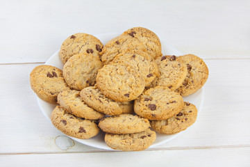 delicious appetizing cookies with chocolate on plate