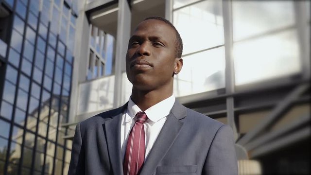 Handsome black african businesss man in the street looking over: future,progress