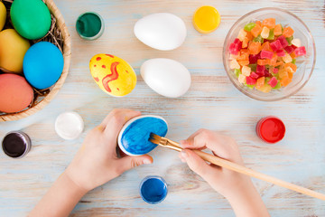 Easter crafts a little boy hands painted blue Easter egg - praparetion for easter