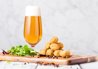 Fried chicken popcorn with fresh salad and beer