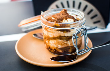 Tiramisu in a jar served on a plate